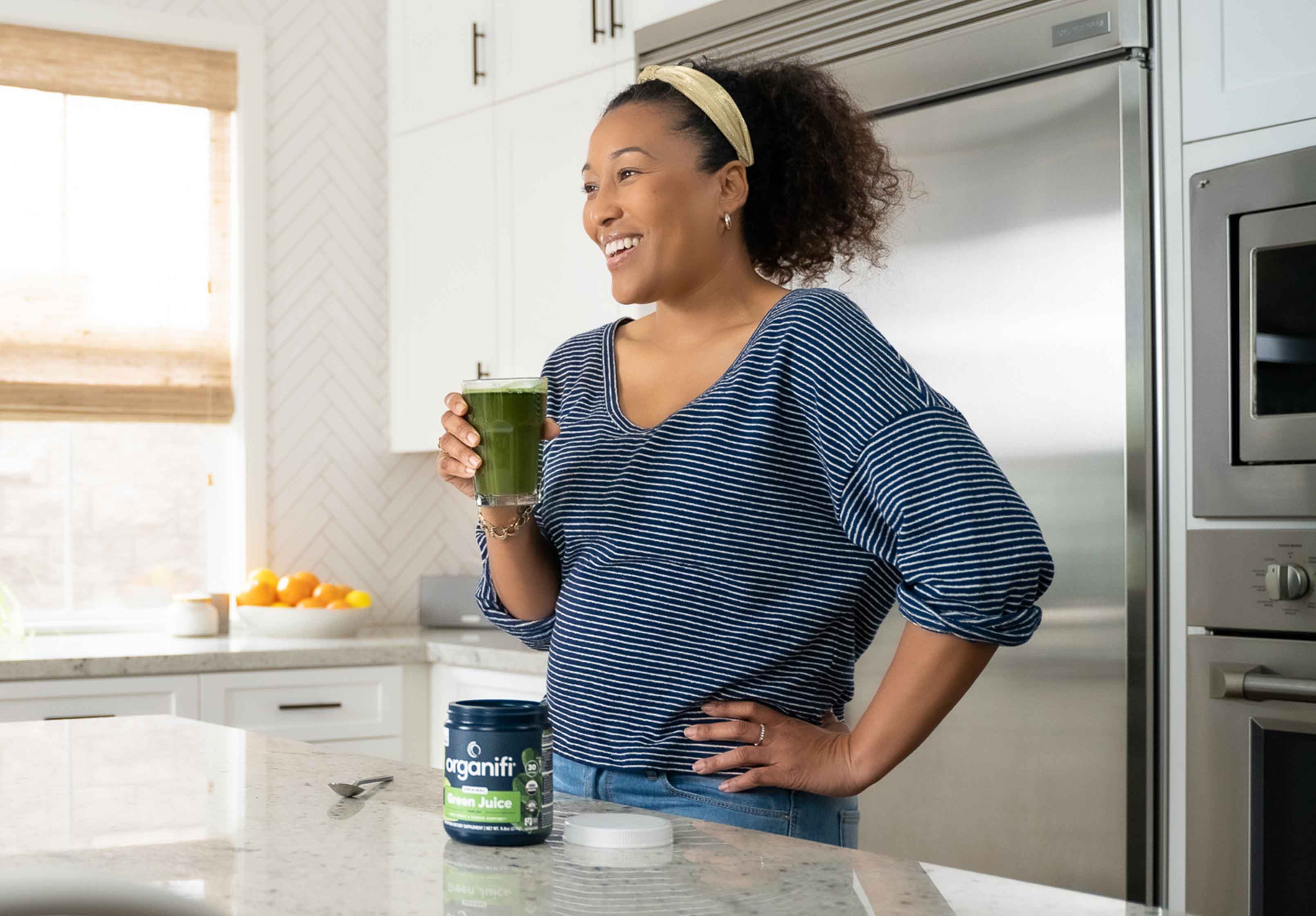 A glass of green juice in the kitchen